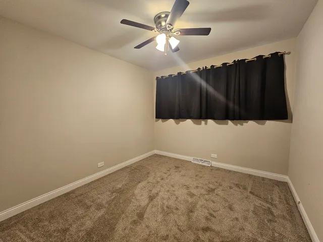 a bed sitting in a bedroom and chandelier