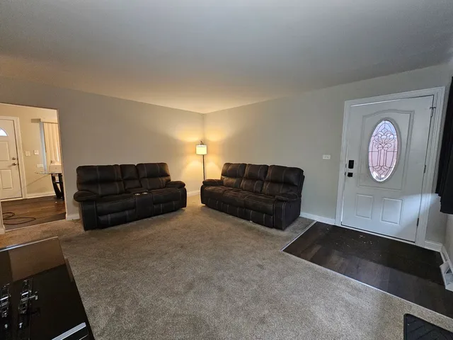 a living room with furniture and a dresser