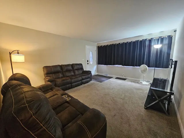 a bed room with a bed and a chair