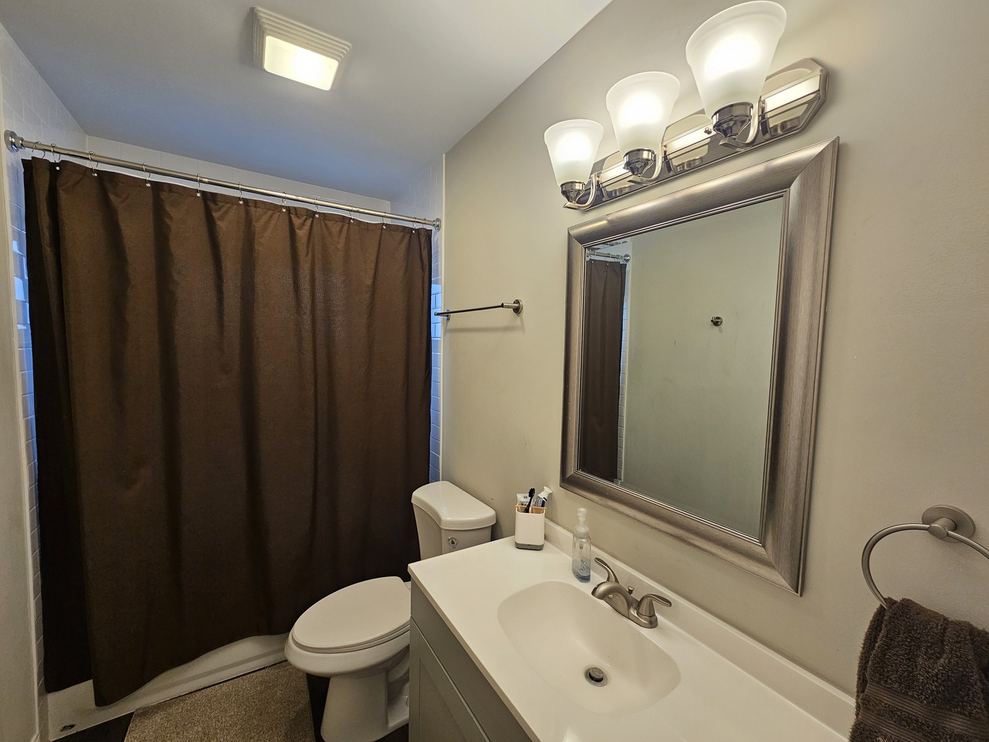 3114 West 163rd Street Markham, IL 60428 - Photo 9 of 16 a bathroom with a sink vanity mirror and toilet