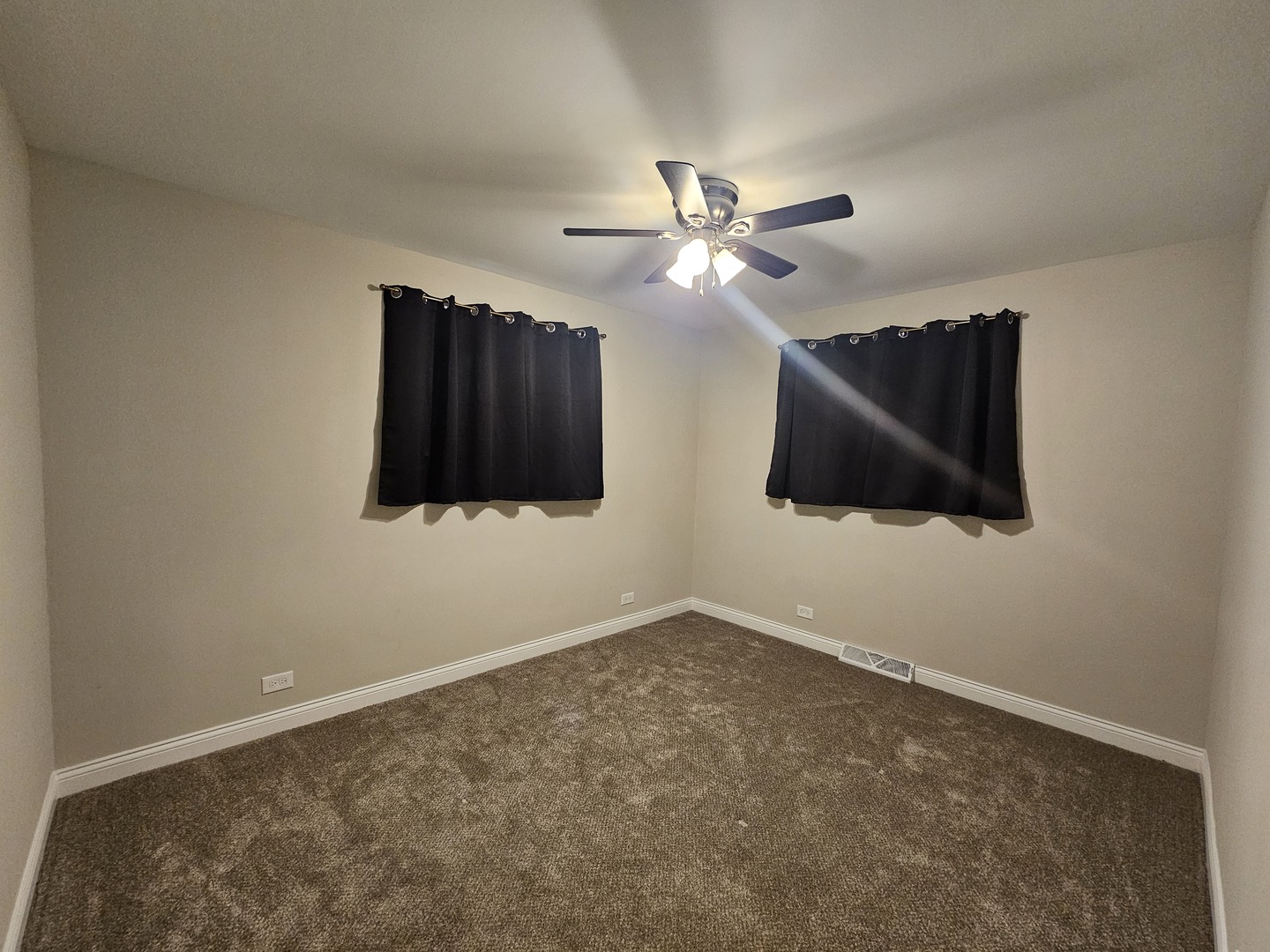 3114 West 163rd Street Markham, IL 60428 - Photo 10 of 16 an empty room with wooden floor ceiling fan and window