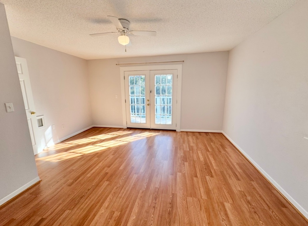 233 Farm To Market 696 Elgin, TX 78621 - Photo 14 of 28 wooden floor in an empty room with a window