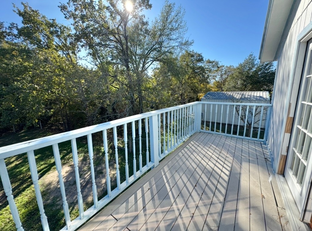 233 Farm To Market 696 Elgin, TX 78621 - Photo 19 of 28 a view of balcony with wooden floor and fence