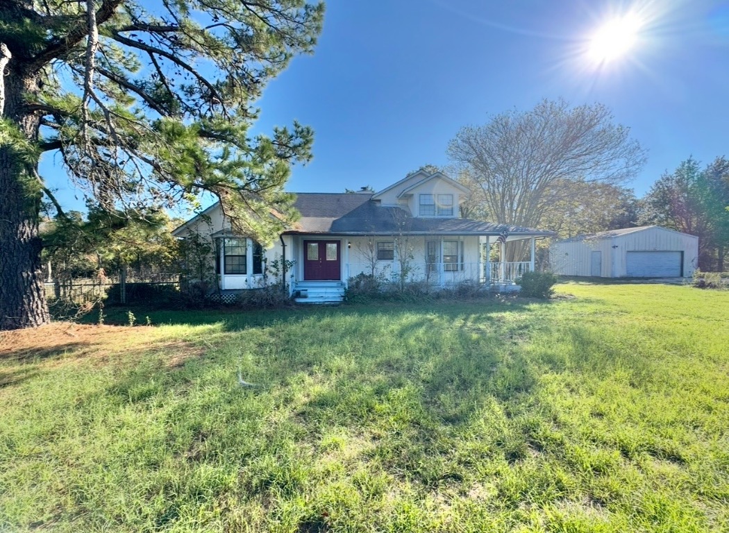 233 Farm To Market 696 Elgin, TX 78621 - Photo 2 of 28 a view of a house with a yard and a large tree