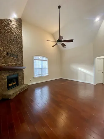a bathroom with a granite countertop sink toilet a mirror and vanity