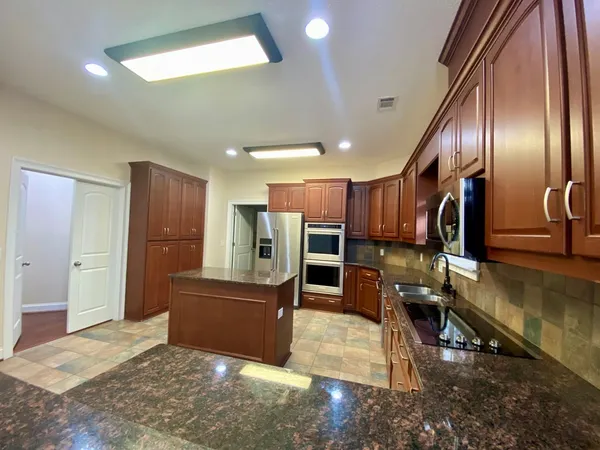 a bathroom with a granite countertop sink double and mirror