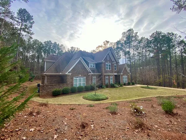 a view of a livingroom with wooden floor and chandelier