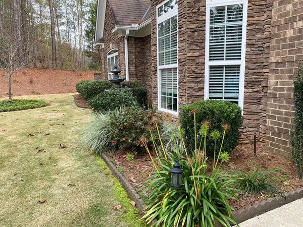 a view of empty room with wooden floor and fireplace