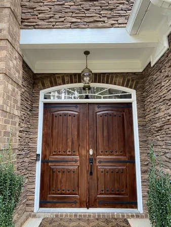 a view of a kitchen with kitchen island granite countertop wooden floor and a view of living room
