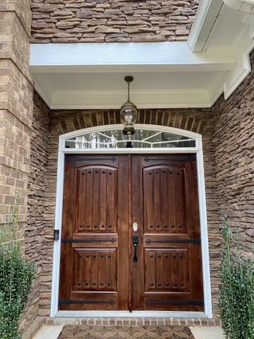 a view of a kitchen with kitchen island granite countertop wooden floor and a view of living room
