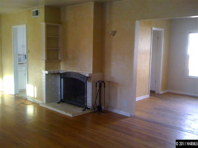 950 Meadow Street Reno, NV 89509 - Photo 4 of 9 an empty room with wooden floor and a window