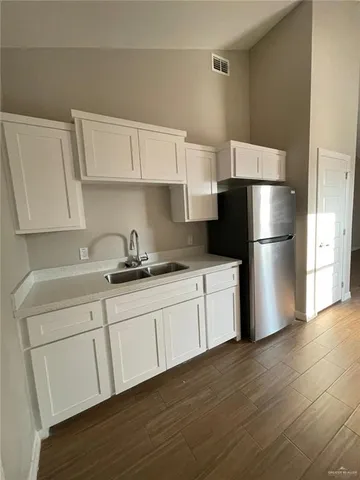 a kitchen with a refrigerator and a sink