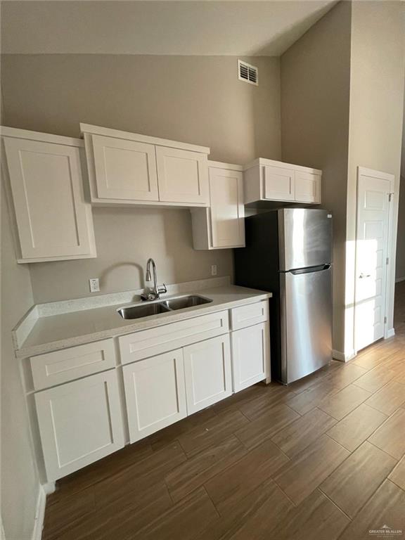 509 Sparrow Road, Unit 3 Weslaco, TX 78596 - Photo 8 of 19 a kitchen with a refrigerator and a sink
