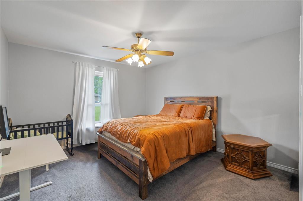 108 Granada Square Canton, TX 75103 - Photo 5 of 11 a bed sitting in a bedroom next to a window