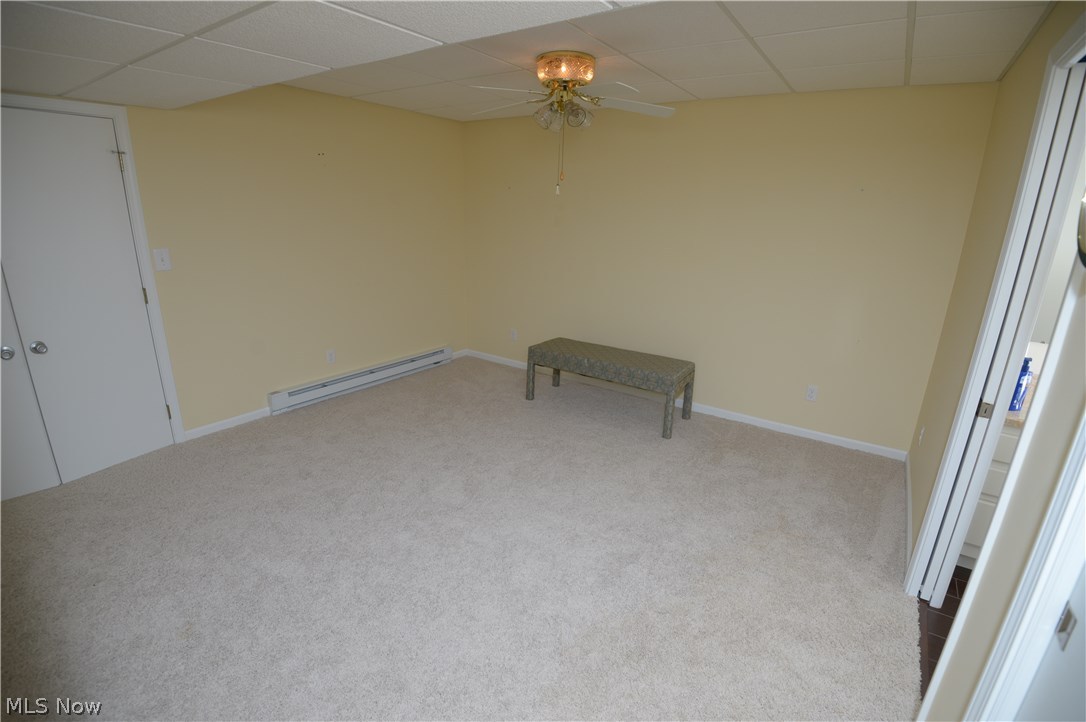 2749 Howland Wilson Road Northeast Warren, OH 44484 - Photo 23 of 25 Through double-doors in the basement sitting area - bonus room (previously used as bedroom) - door to the right takes you to the full-bath - doors to the left is a large closet area that you'd walk through to get to the storage area