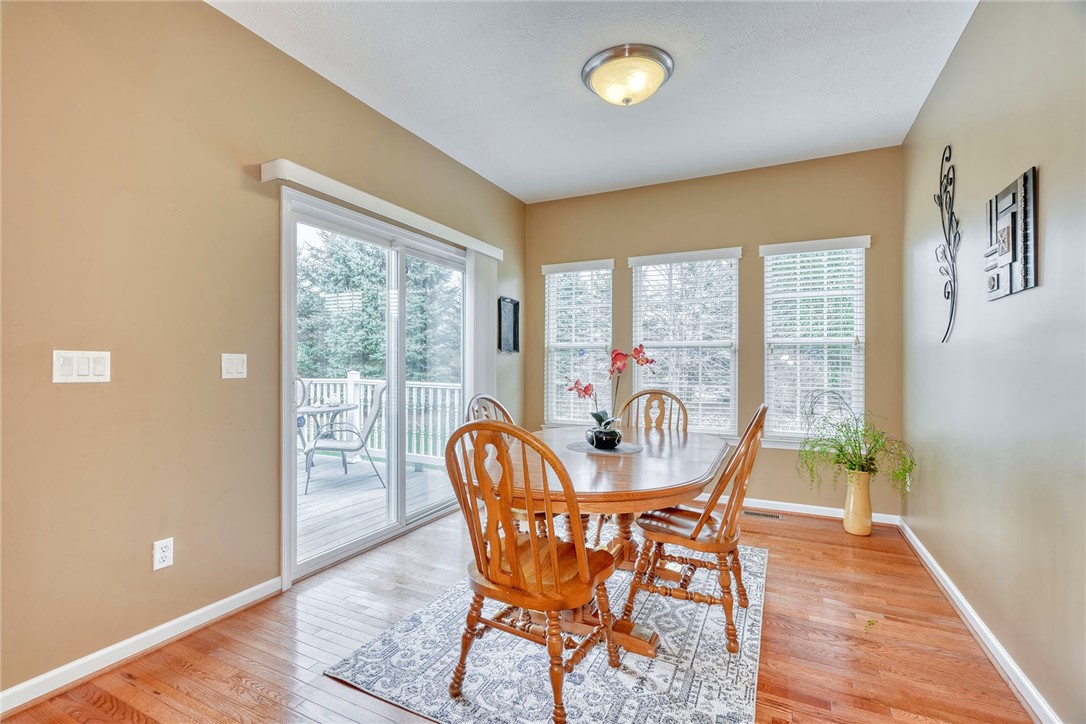 1082 Railway Crossing Webster, NY 14580 - Photo 7 of 43 DINING AREA WITH SLIDER TO PRIVATE BACKYARD DECK