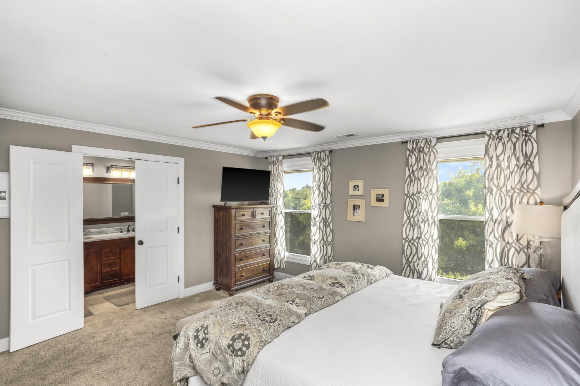 8733 Haselton Road Nashville, TN 37221 - Photo 12 of 28 a bedroom with a bed and a chandelier