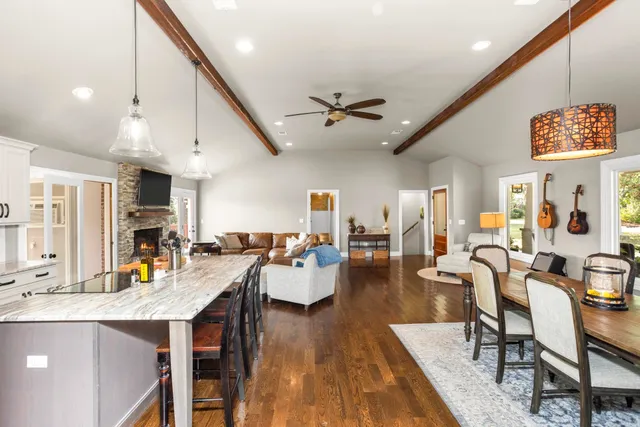 a living room with lots of furniture and kitchen view