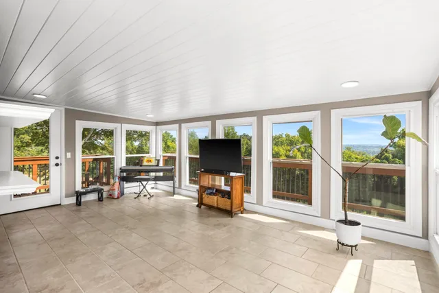 a living room with furniture and large window