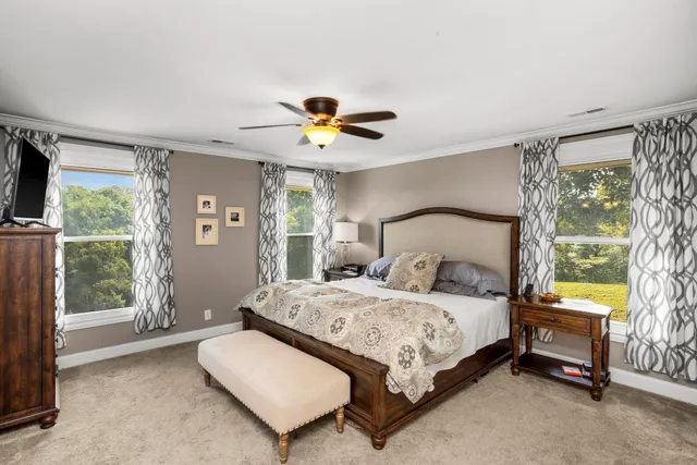 a bedroom with a bed and a chandelier