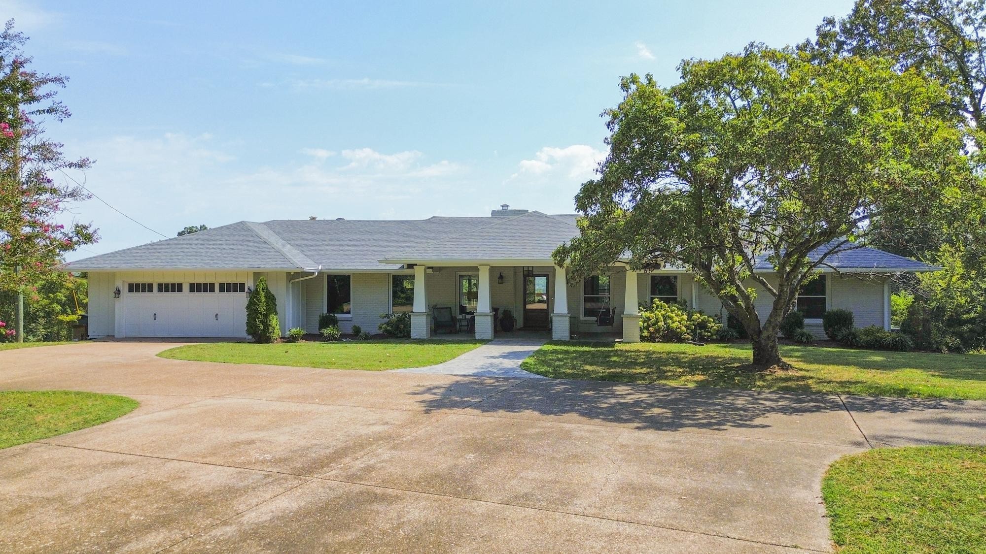 8733 Haselton Road Nashville, TN 37221 - Photo 2 of 29 a front view of a house with a yard and garage