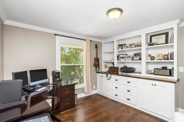 a view of a workspace with furniture and a window
