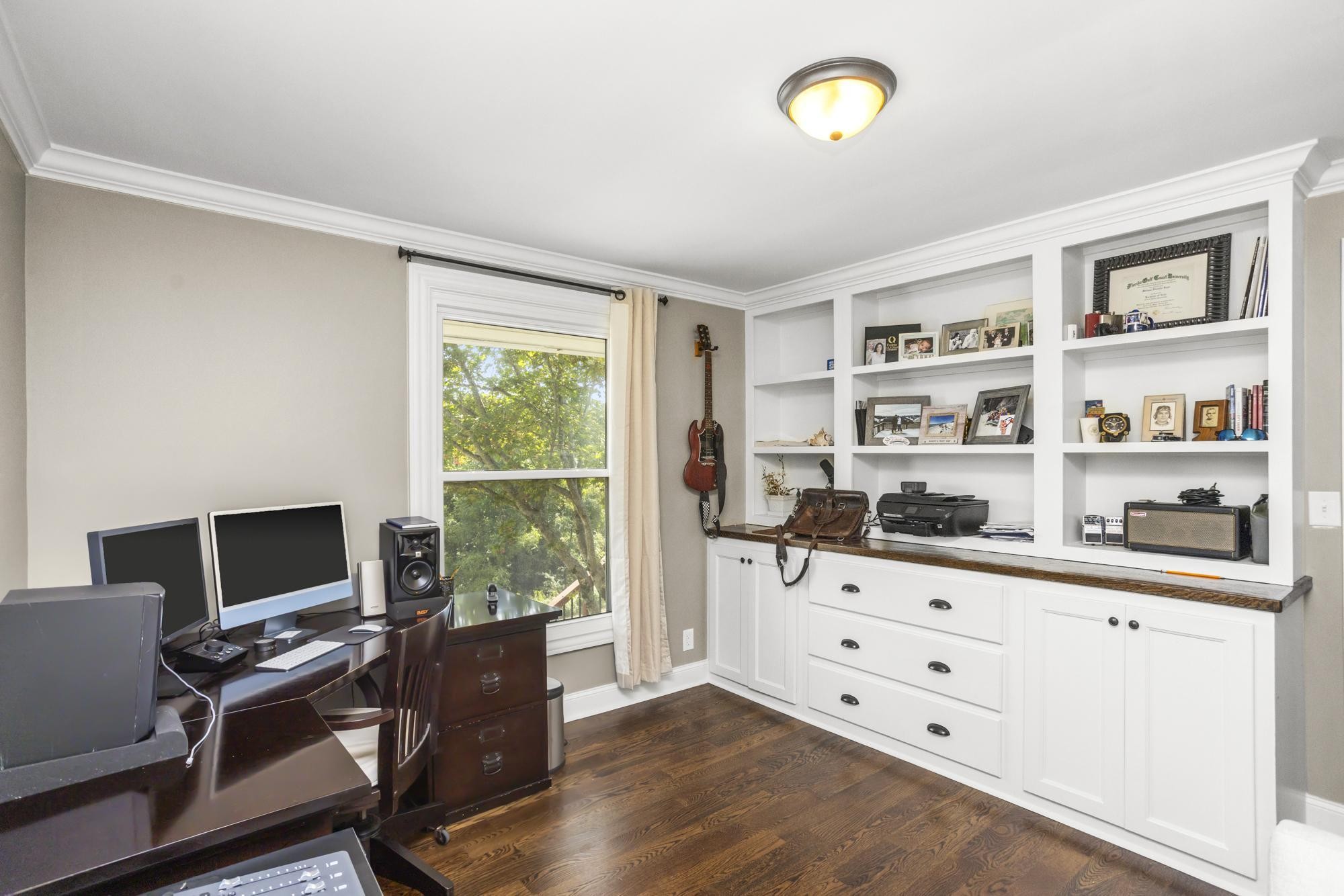 8733 Haselton Road Nashville, TN 37221 - Photo 21 of 29 a view of a workspace with furniture and a window