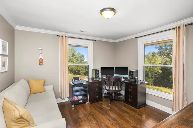 a view of a livingroom with workspace and a window