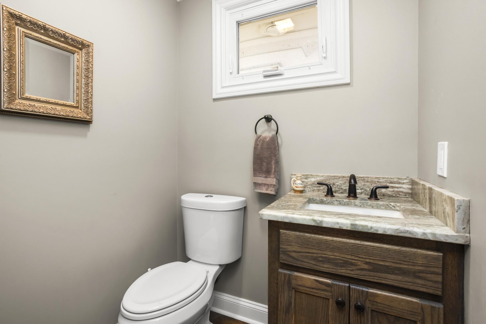 8733 Haselton Road Nashville, TN 37221 - Photo 23 of 29 a bathroom with a toilet sink and mirror