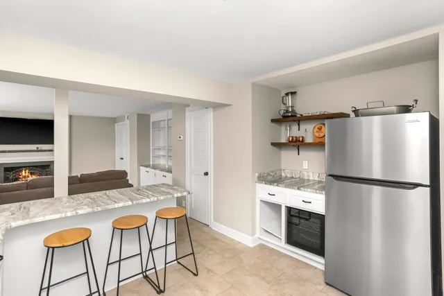 a kitchen with stainless steel appliances granite countertop a refrigerator and a stove top oven