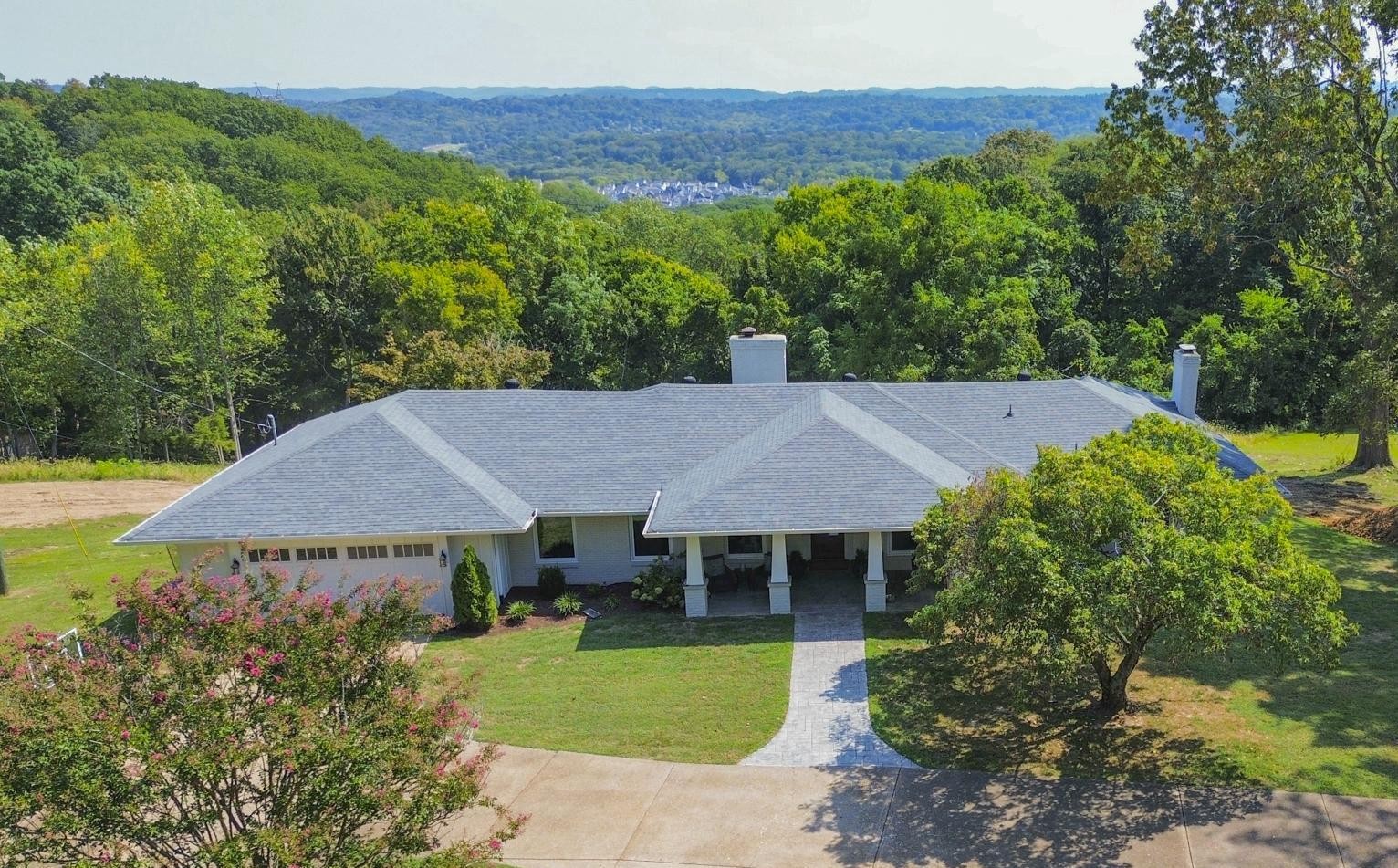 8733 Haselton Road Nashville, TN 37221 - Photo 3 of 29 a view of a house with a garden