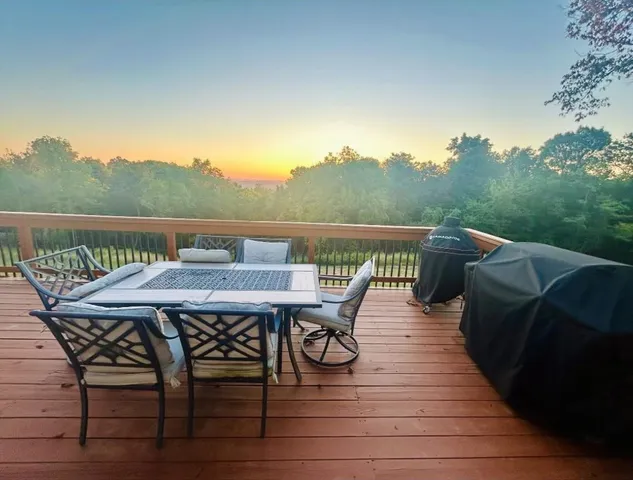 a view of a roof deck with table and chairs