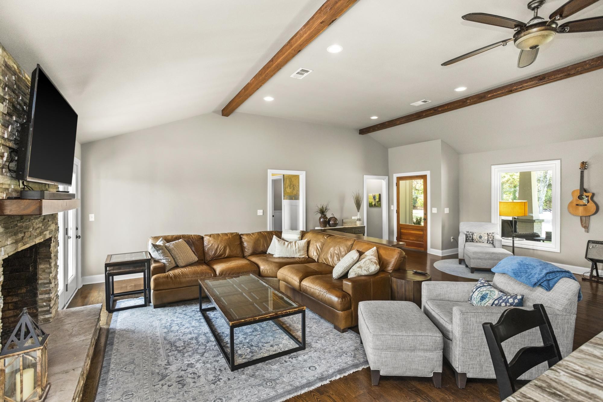 8733 Haselton Road Nashville, TN 37221 - Photo 6 of 28 a living room with furniture a fireplace and a flat screen tv