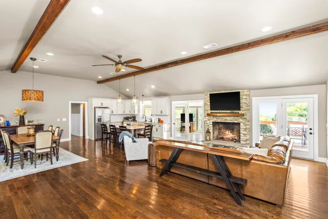 a living room with furniture and a fireplace with wooden floor