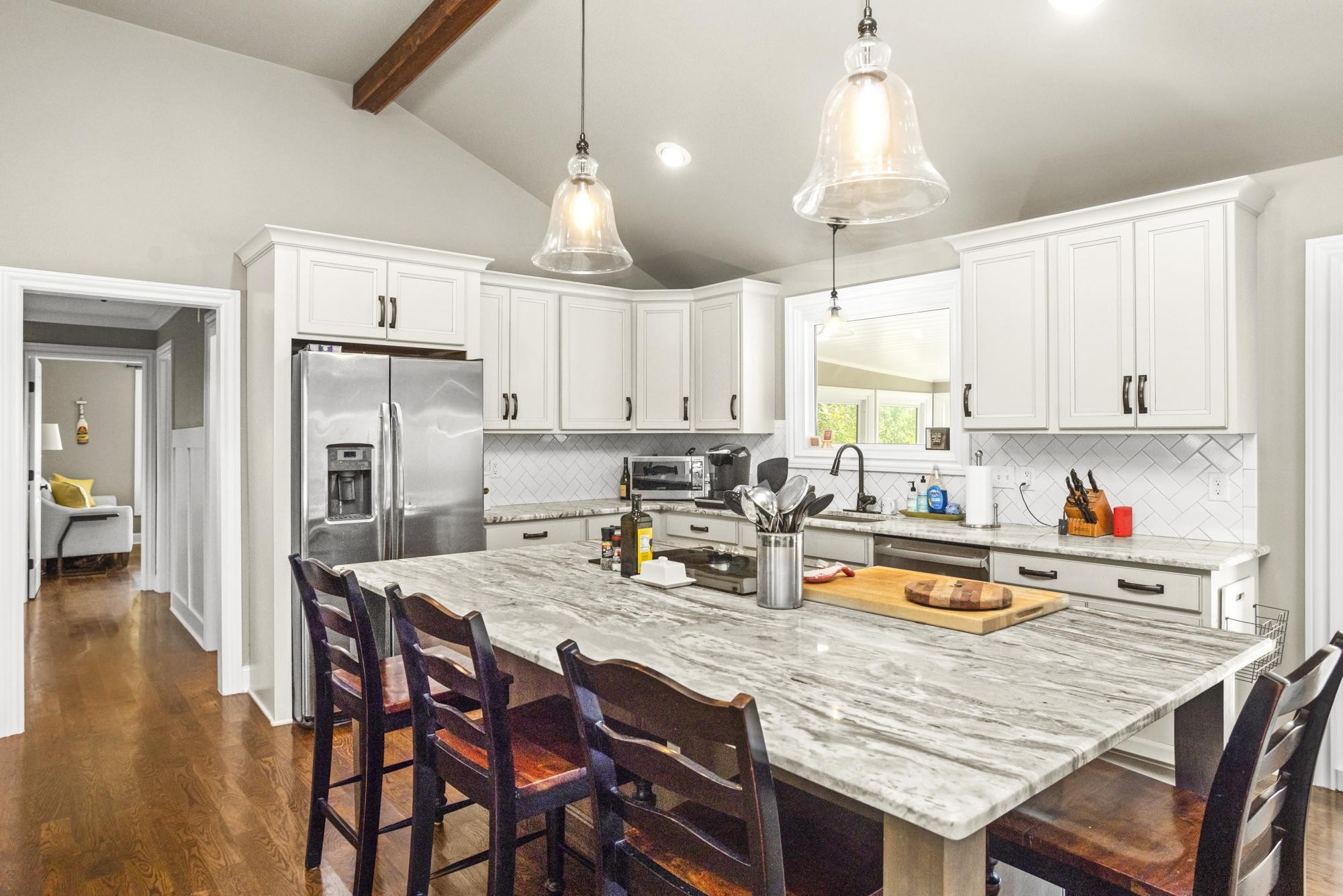 8733 Haselton Road Nashville, TN 37221 - Photo 10 of 28 a kitchen with stainless steel appliances granite countertop a dining table chairs refrigerator and cabinets