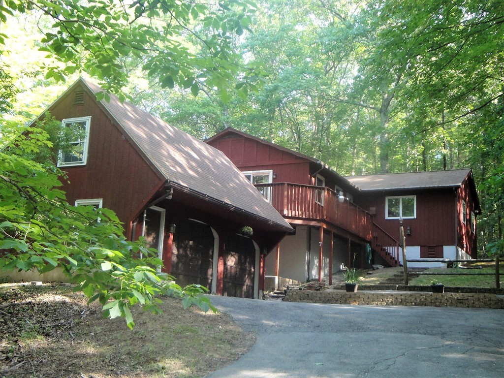 7 Carey Road Sturbridge, MA 01566 - Photo 1 of 27 a front view of a house with a garden