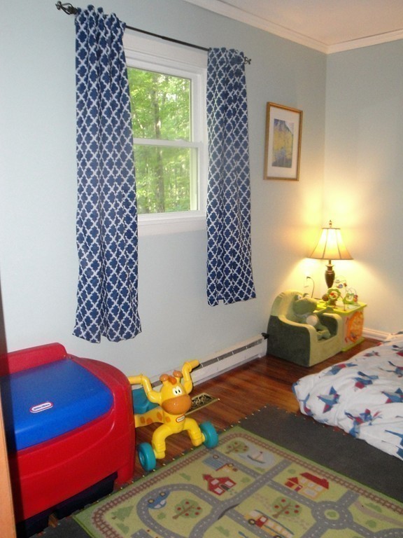 7 Carey Road Sturbridge, MA 01566 - Photo 18 of 27 a bedroom with a bed and a lamp on dresser