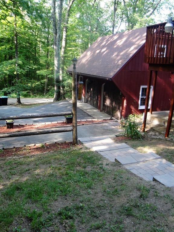 7 Carey Road Sturbridge, MA 01566 - Photo 24 of 27 a view of house with backyard and outdoor seating