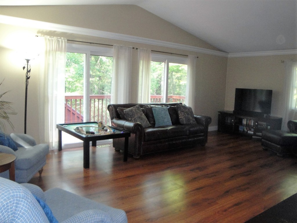 7 Carey Road Sturbridge, MA 01566 - Photo 6 of 27 a living room with furniture a flat screen tv and a large window