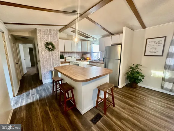 a kitchen with refrigerator and window