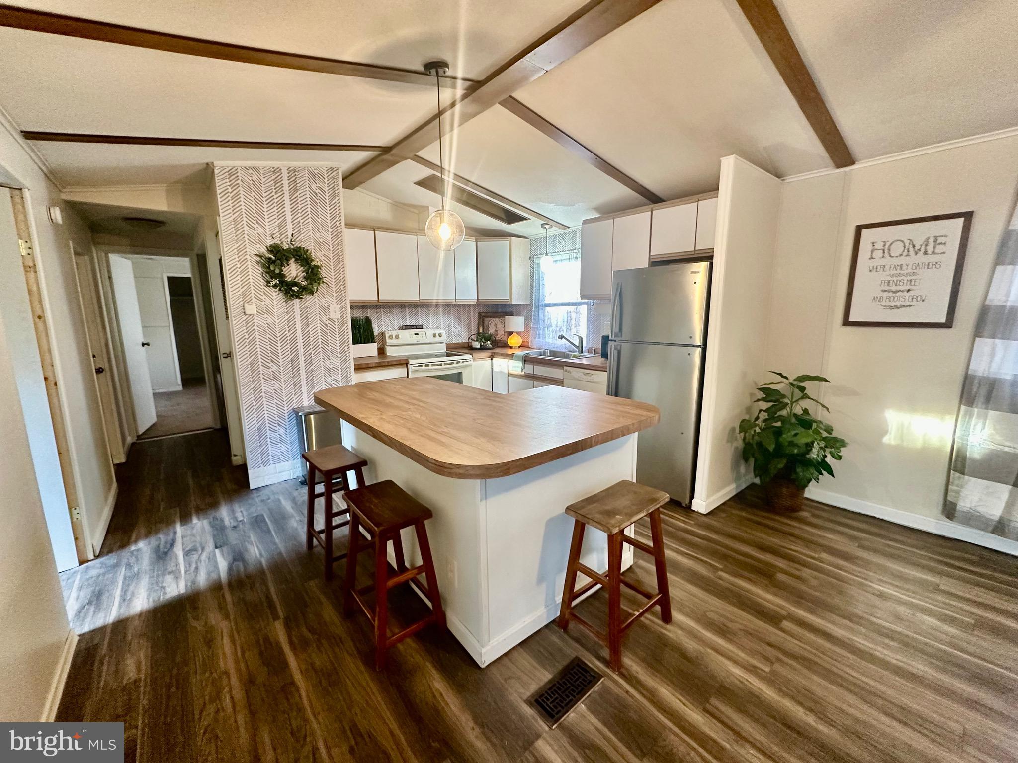 a kitchen with refrigerator and window