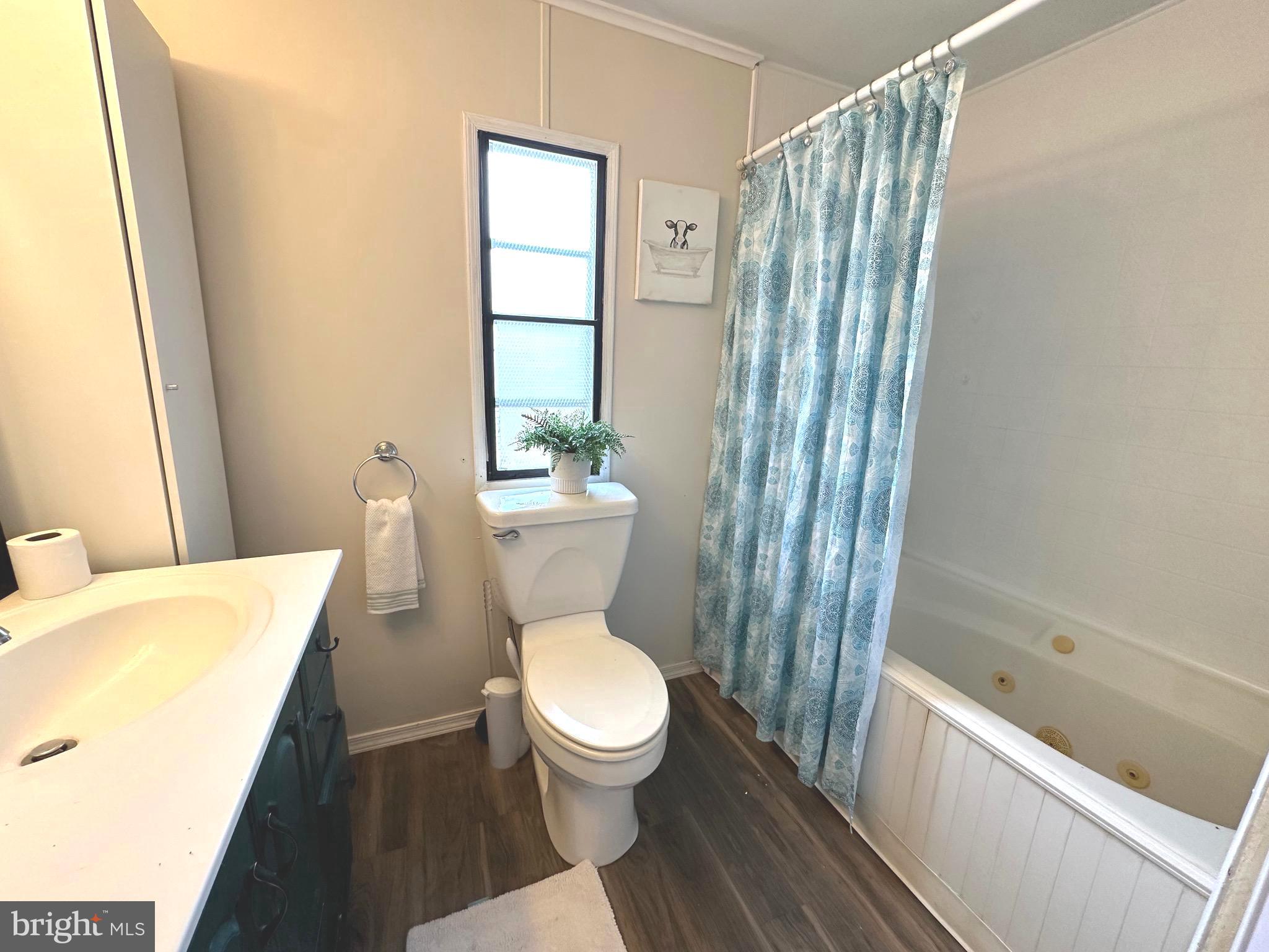 3532 Wagon Train Road Middle River, MD 21220 - Photo 17 of 28 a white toilet sitting next to a bathroom sink and tub