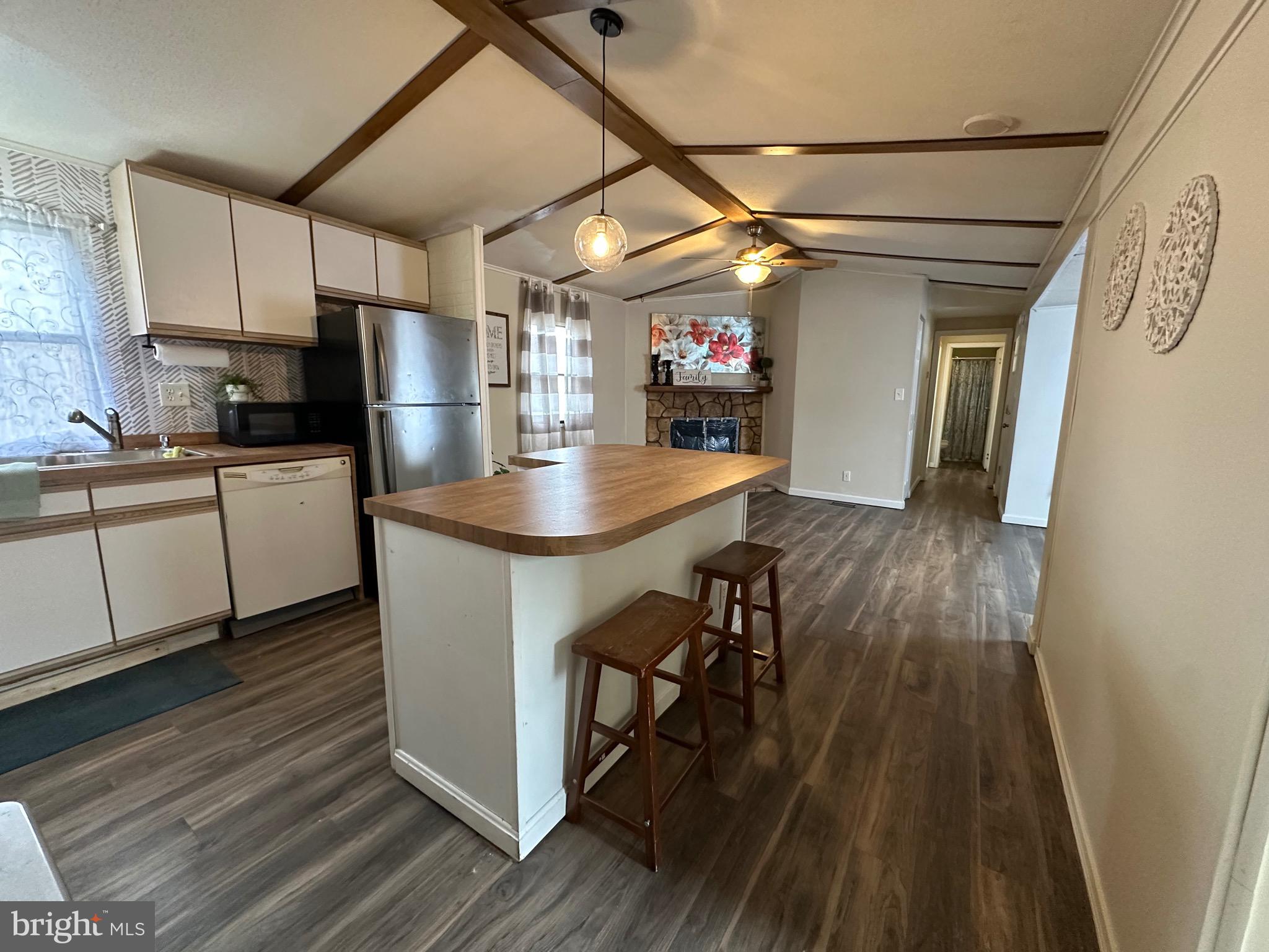 3532 Wagon Train Road Middle River, MD 21220 - Photo 4 of 28 a kitchen with stainless steel appliances a stove a refrigerator a sink dishwasher and a dining table with wooden floor