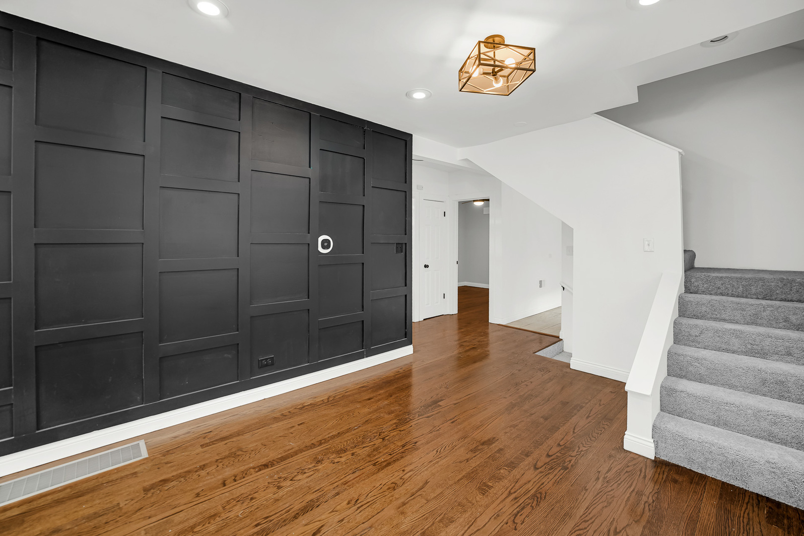 9327 South Elizabeth Street Chicago, IL 60620 - Photo 3 of 18 a view of an empty room with wooden floor and a bathroom