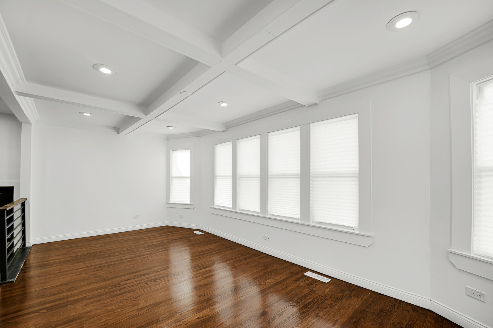 9327 South Elizabeth Street Chicago, IL 60620 - Photo 4 of 18 an empty room with wooden floor and windows