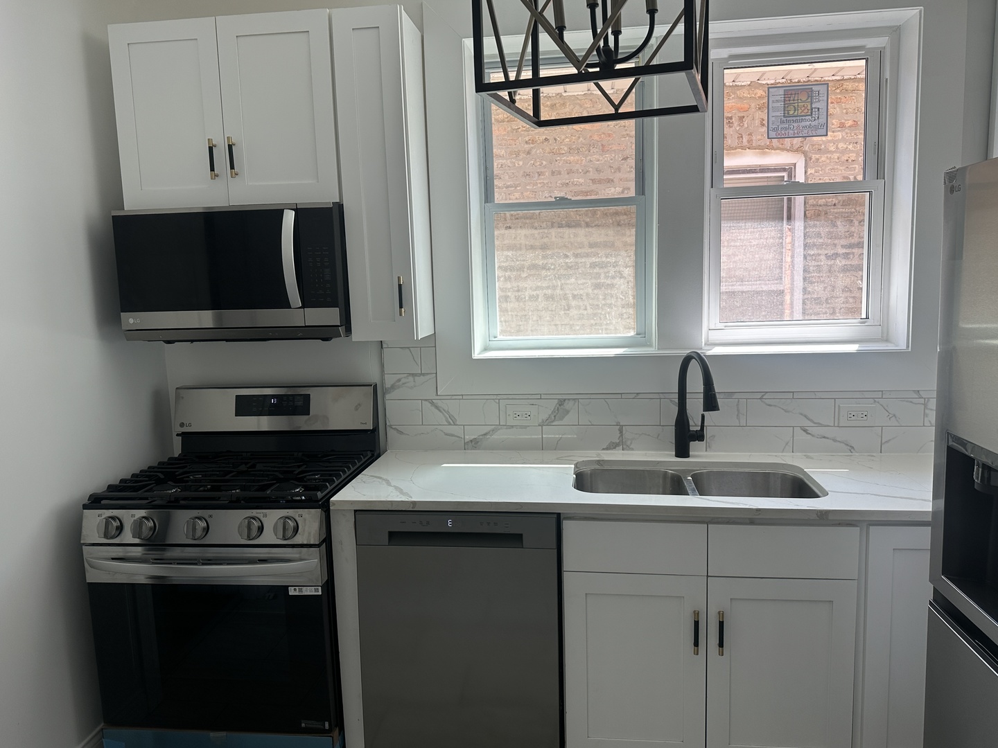 9327 South Elizabeth Street Chicago, IL 60620 - Photo 7 of 18 a kitchen with stainless steel appliances granite countertop a sink stove and microwave