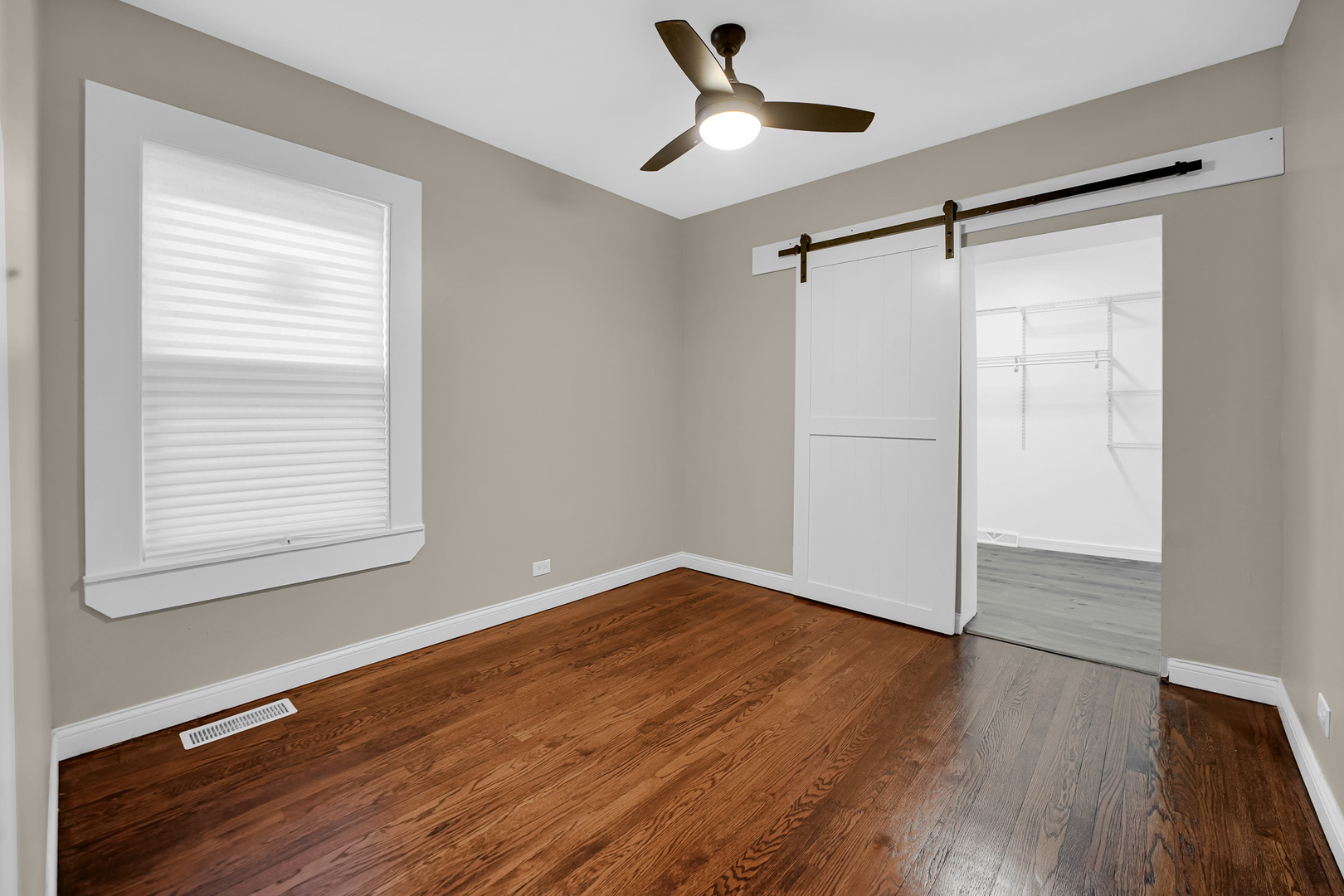 9327 South Elizabeth Street Chicago, IL 60620 - Photo 10 of 18 a view of an empty room with wooden floor and a window
