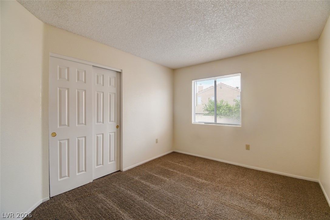 5 Tarryall Terrace Henderson, NV 89074 - Photo 28 of 44 Comfortable carpeted bedroom with window views of the neighborhood.