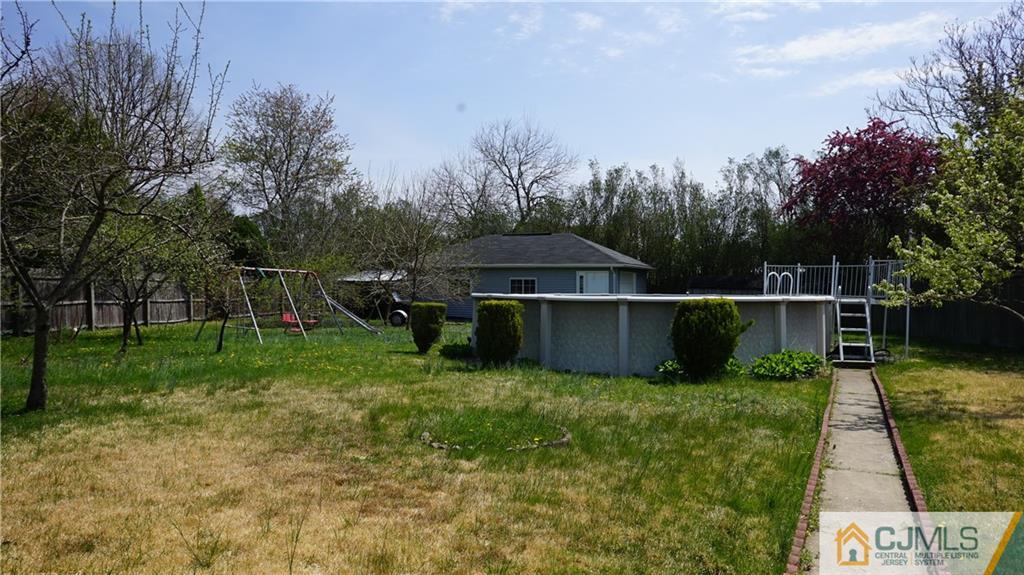 8 Plumstead Road Sewell, NJ 08080 - Photo 2 of 25 a view of a backyard with wooden fence and large trees