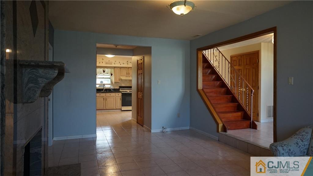 8 Plumstead Road Sewell, NJ 08080 - Photo 12 of 25 a view of a hallway with wooden floor and staircase